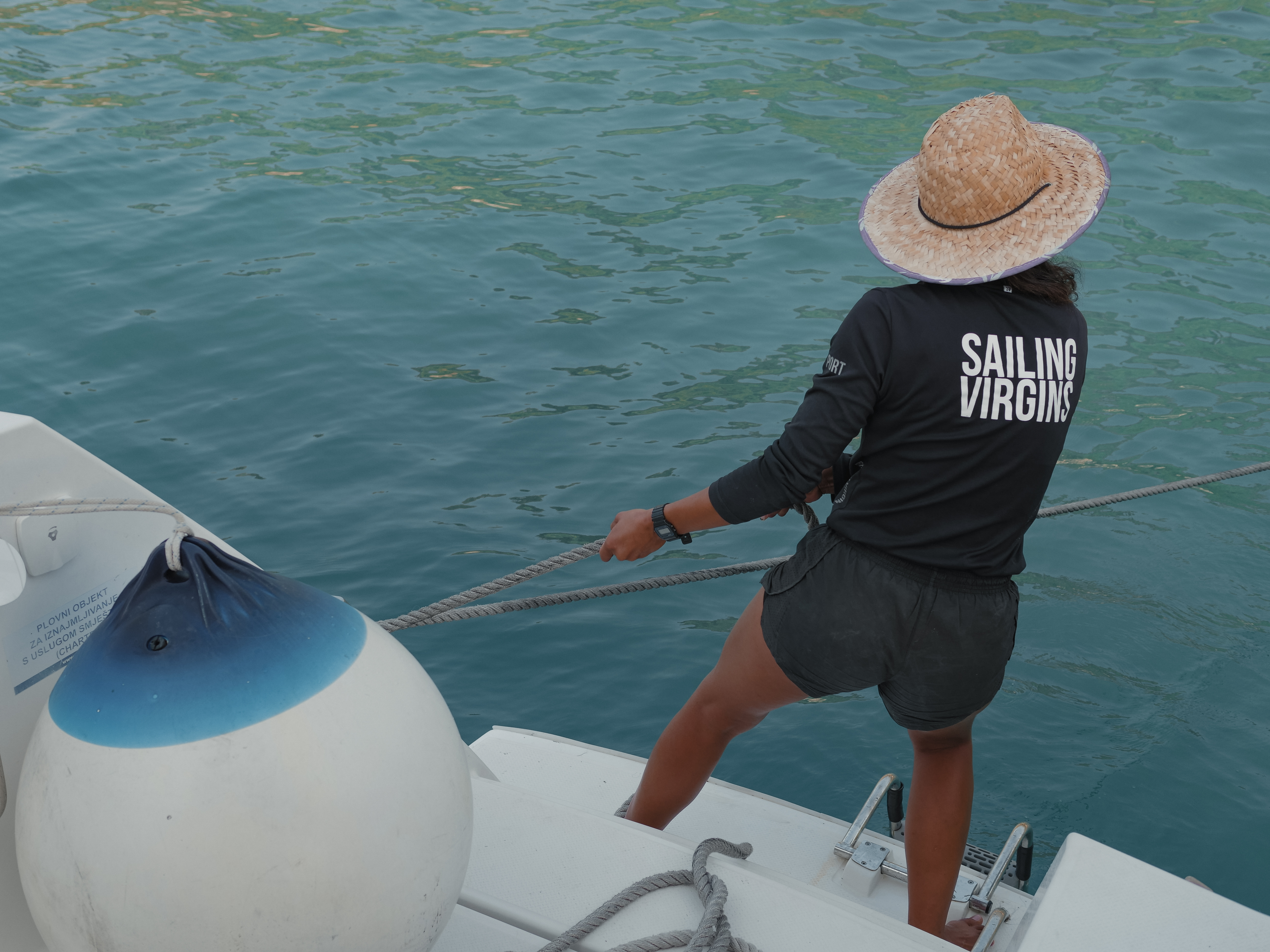 Sailor pulling on mooring lines