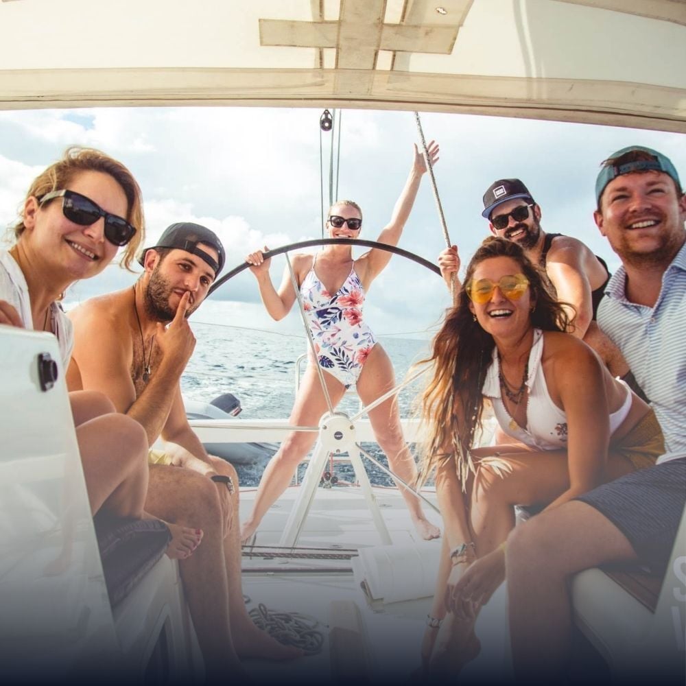Sailors learning to sail on a Sailing Virgins live-aboard yacht in turquoise Caribbean waters
